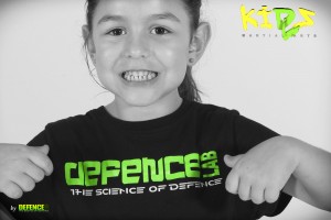 young girl showing off her defence lab t-shirt